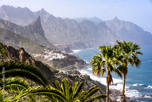 Spain, Canary Islands, Almaciga, Mountainous coastline of Tenerife island with village in background photo