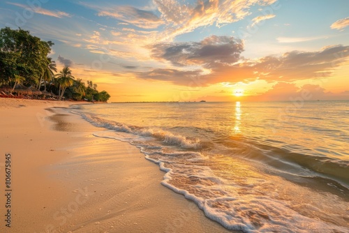 Golden sunlight reflecting on gentle ocean waves and sandy beach