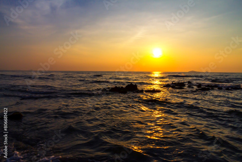 Sunrise on water in morning at beach