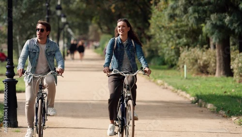 Wallpaper Mural Smiling couple cycling in urban park Torontodigital.ca