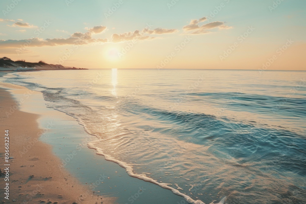 Fototapeta premium Sunset over calm sea with sandy shore