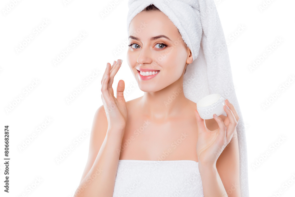 Portrait of charming woman in towel and turban on head, applying face cream for problem combined skin holding bank with balm isolated on white background. Wellness wellbeing concept