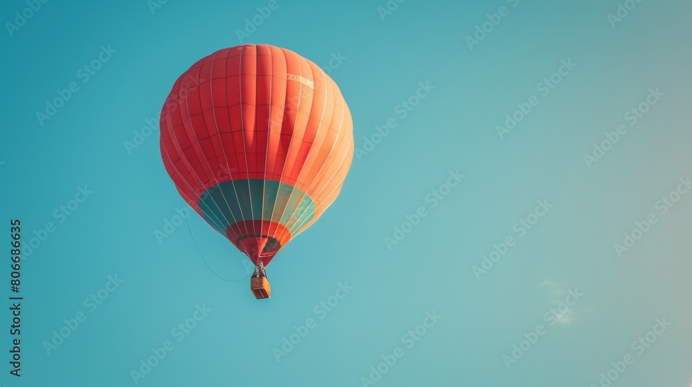Fototapeta premium A clear blue sky with a single hot air balloon floating peacefully.
