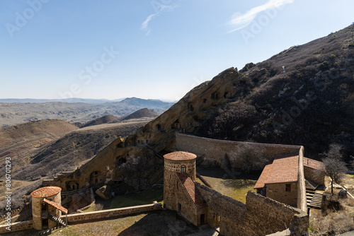 Majestic Fortress: Aerial View of a Castle Amidst the Mountains photo