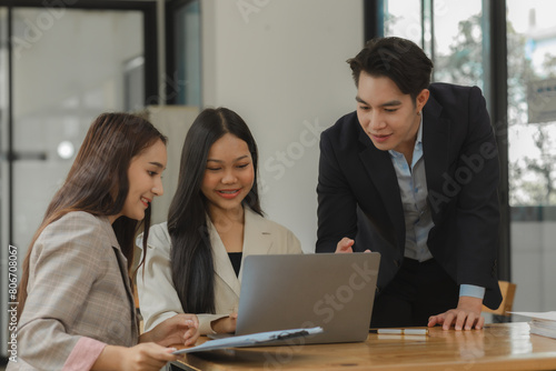 employees are discussing and exchange their idea to solve some miner problem, group of entrepreneurs is planning strategy to increase their income in the office, happy working © Chadaporn
