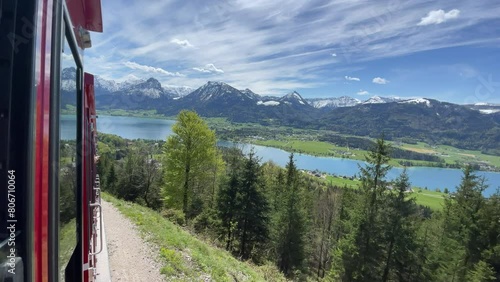 View on lake sankt wolfgangsee from austrian alp mountain schafsberg. Red cog cable railway or touristic train in summer in Austria. sunny weather. Tourism of Salzkammergut. Nature scenery. photo