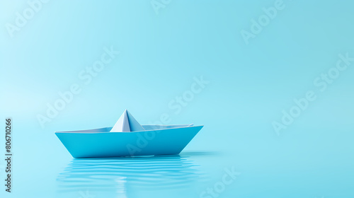 A simple paper boat floats on the water