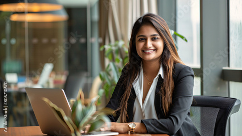 A  young indian woman working as a receptionist in office.