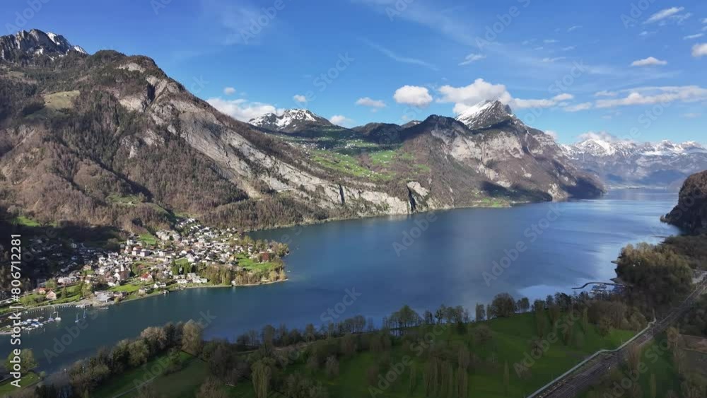 Breathtaking aerial view of Walensee, Weesen, showing the vibrant village by the serene blue lake, nestled between rugged mountains. Breathtaking aerial view of Walensee, Weesen, showing the vibrant village by the serene blue lake, nestled between rugged mountains.