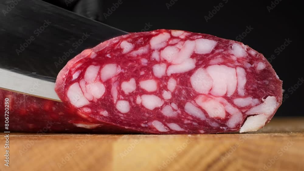 Chef sliced sausages salami, closeup