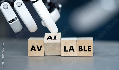 Robot hand turns cube and puts the letter 'AI' in to the word 'available'. Symbol that artificial intelligence technology is available.