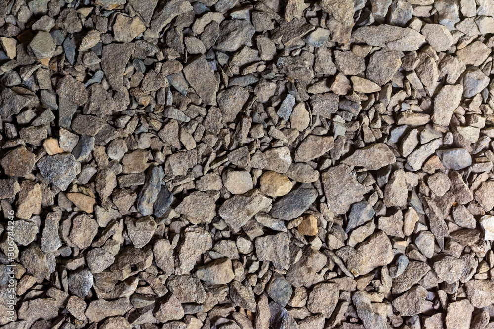 The background is made of small stone. The texture of crushed stone The background is made of small stone. The texture of crushed stone