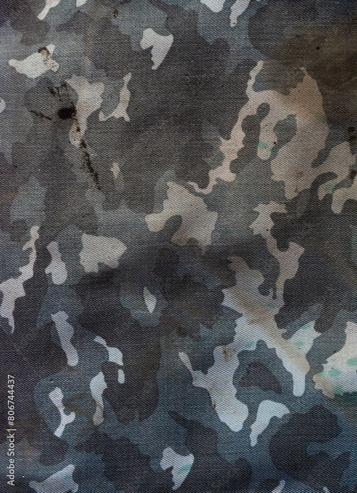 Camouflage fabric covered with dirt, stains, dust