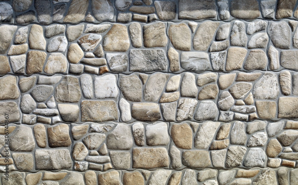 Fototapeta premium Rustic stone paneling for outdoor home coating with natural rocks. Background and texture. 