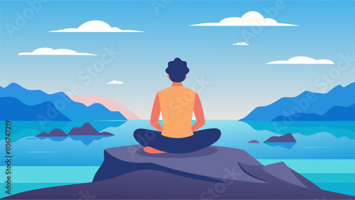 A snapshot of a person sitting on a large rock formation legs crossed and hands resting on their lap overlooking a vast ocean as they meditate..