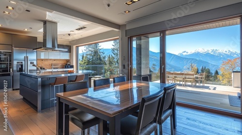 open kitchen with mountain view featuring a wood table and chairs  a stainless steel oven  and a silver faucet  set against a white ceiling and wood floor
