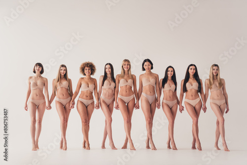 No filter photo of stunning gorgeous ladies hold hands make feminists unity share body positive concept isolated pastel color background