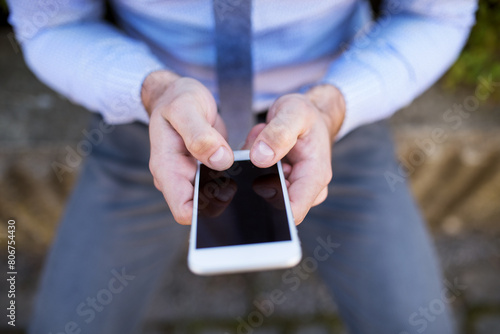 Close up of hands holding smartphone. Businessman scrolling on smartphone.