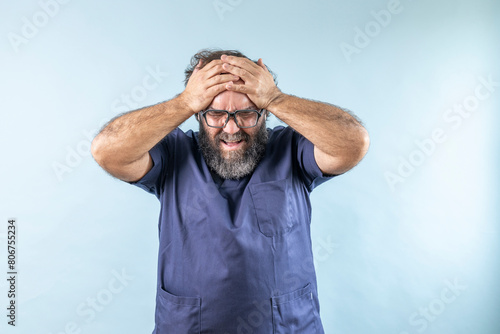doctor holding his forehead making a gesture of pressure, stress or headache
