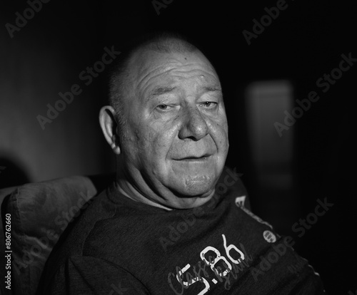 black and white portrait of an old man in low light