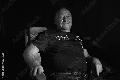 black and white portrait of an old man in low light