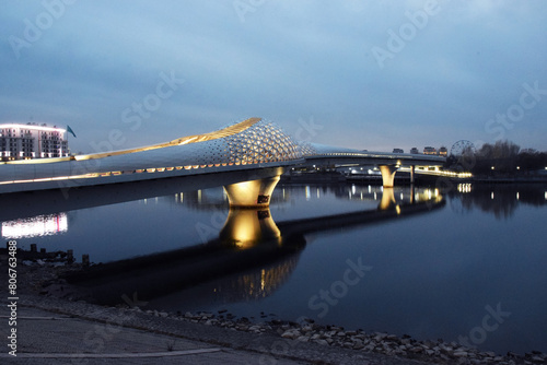 The Atyrau Bridge in the capital of Kazakhstan, Astana, connects the right and left banks of the Ishim (Yesil) River. The bridge is pedestrian, unusually and beautifully illuminated.
