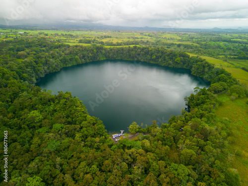 Aerial view of Rio Cuarto lake in Alajuela  Costa Rica  surrounded by dense greenery