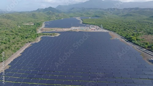 PV panels installed on solar farm in clearcut jungle landscape, Bani. Drone photo