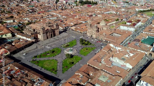 Aerial footage of the Cuzco Main Square with the cityscape of Cusco on a sunny day in Peru photo