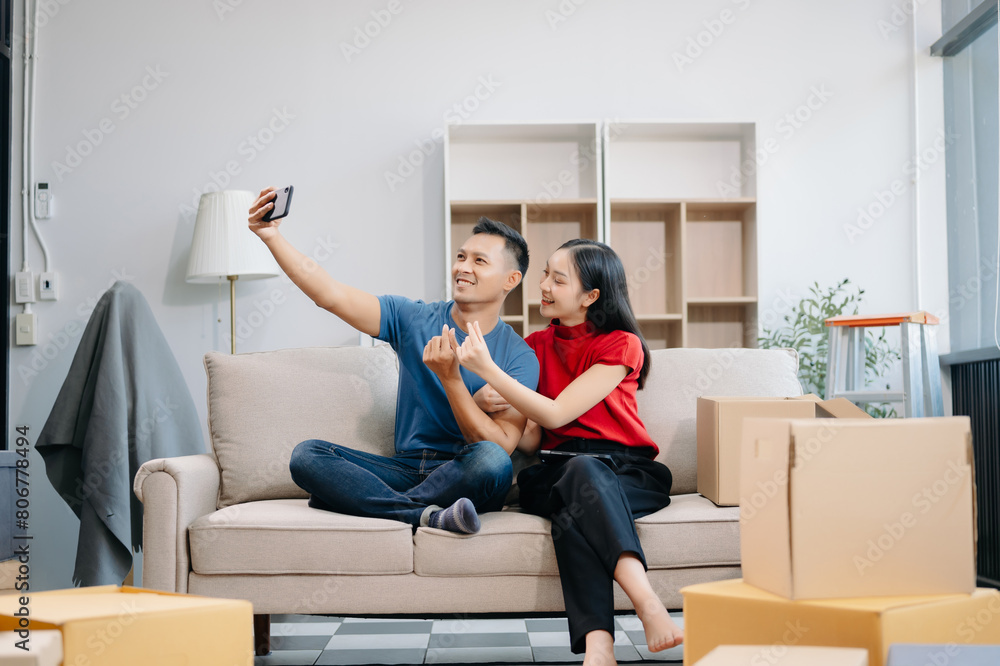 Asian young attractive couple man and woman use tablet and smartphone online shopping furniture decorate house Asian young attractive couple man and woman use tablet and smartphone online shopping furniture decorate house