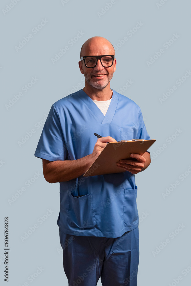 Portrait of a physiotherapist in light blue gown and holding a wooden folder. Portrait of a physiotherapist in light blue gown and holding a wooden folder.