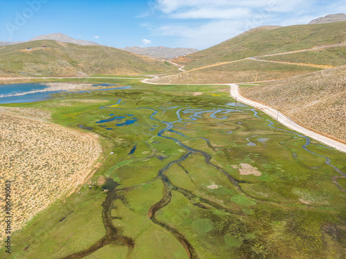 The meander in Antalya Sobucimen plateau. Aerial view of complex waterways weaving  through lush green fields photo