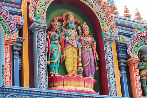 God Vishnu or Janardana Swami with his consorts Sri Devi and Bhu Devi. Stucco molding on the roof of a temple in Varkala, Kerala, India. photo