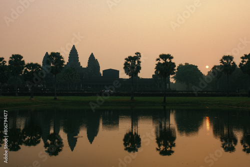 Angkor Wat with Lake Reflection, Yellow Sky, and Silhouetted Trees