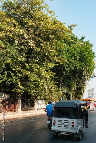 Phnom Penh Streets Alive with Cars and TukTuks Amidst Greenery