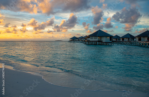 Obraz na płótnie Incredible sunset in Maldives. Sea view of luxury holiday villas with soft led lights under colorful sky. beautiful twilight sky w salonie