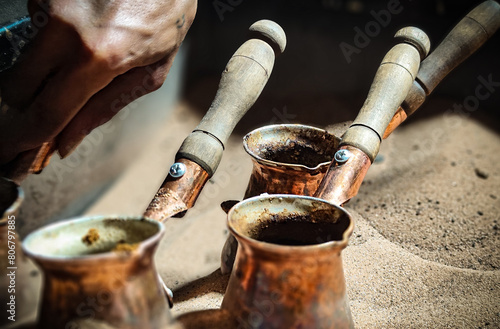 Preparing local coffee on hot sand photo