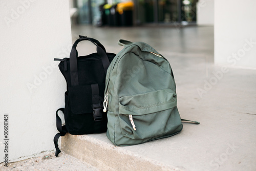 Obraz na płótnie A lost or forgotten backpacks on a floor on an open platform. Forgotten luggage. Lost hand luggage. The concept of travel. w salonie