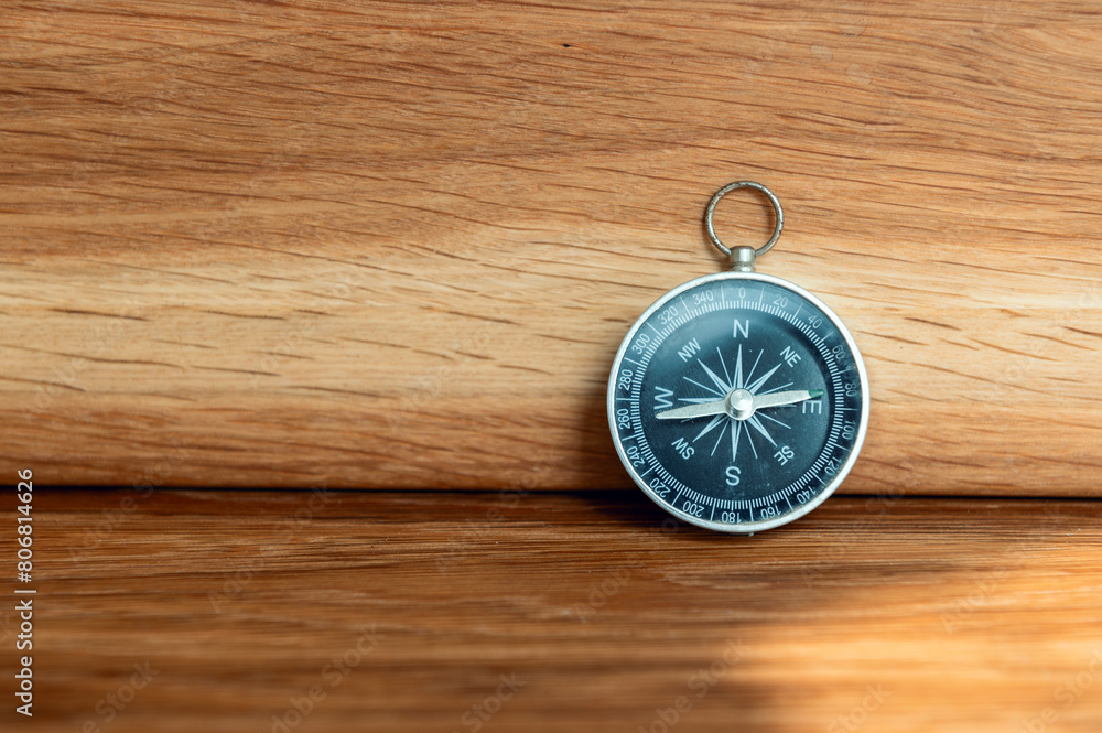 Compass on wooden background with copy space using as direction Compass on wooden background with copy space using as direction
