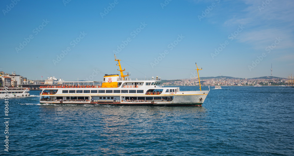 Touristic sightseeing ships in Golden Horn bay against blue sky and clouds. Istanbul, Turkey. During sunny summer day.