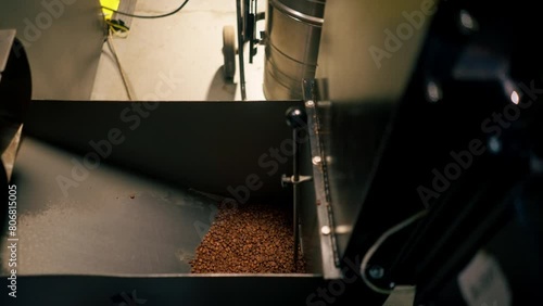 close-up at a coffee factory in roasting machine tightening coffee beans photo