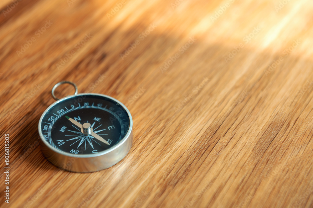 Compass on wooden background with copy space using as direction Compass on wooden background with copy space using as direction