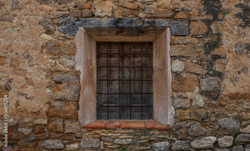 Window in the old stone wall. © eskstock