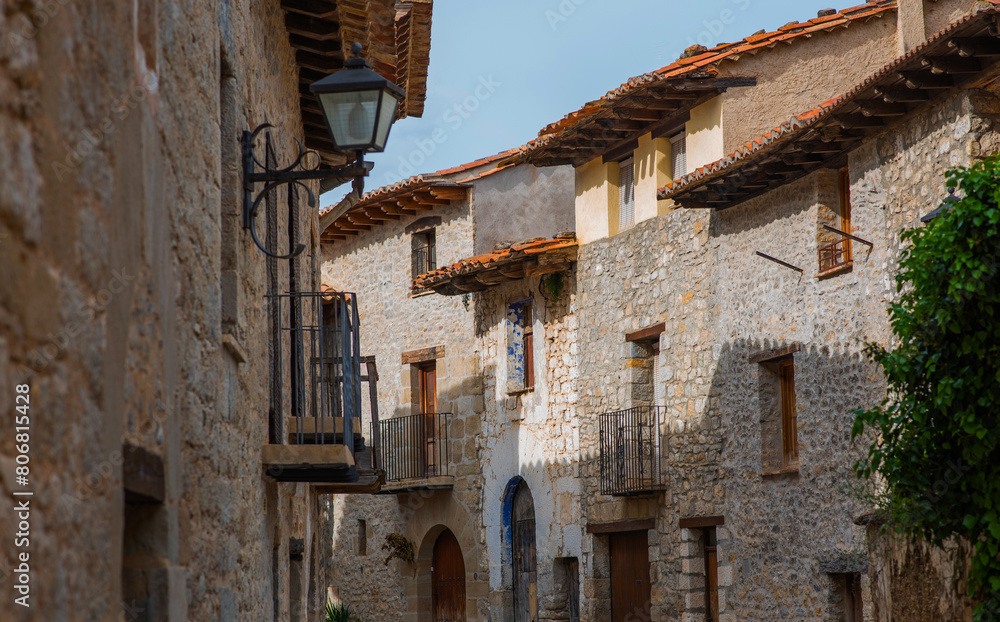 Old charming streets. Typical village with stone facades. Architecture and sights of Spain.