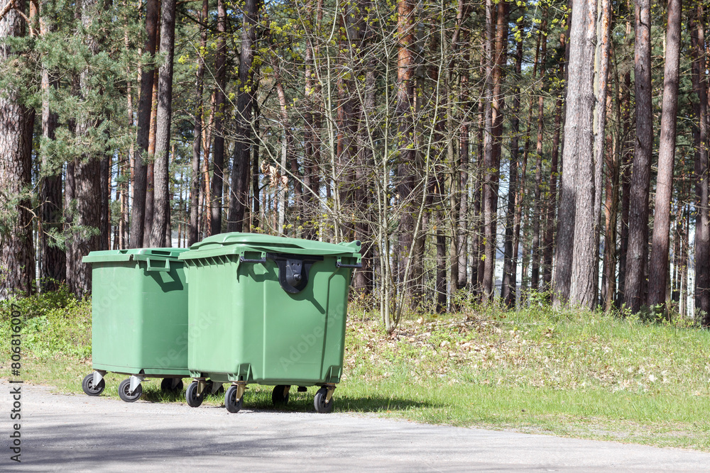 green color garbage cans in the park on the background of the forest
green color garbage cans in the park on the background of the forest