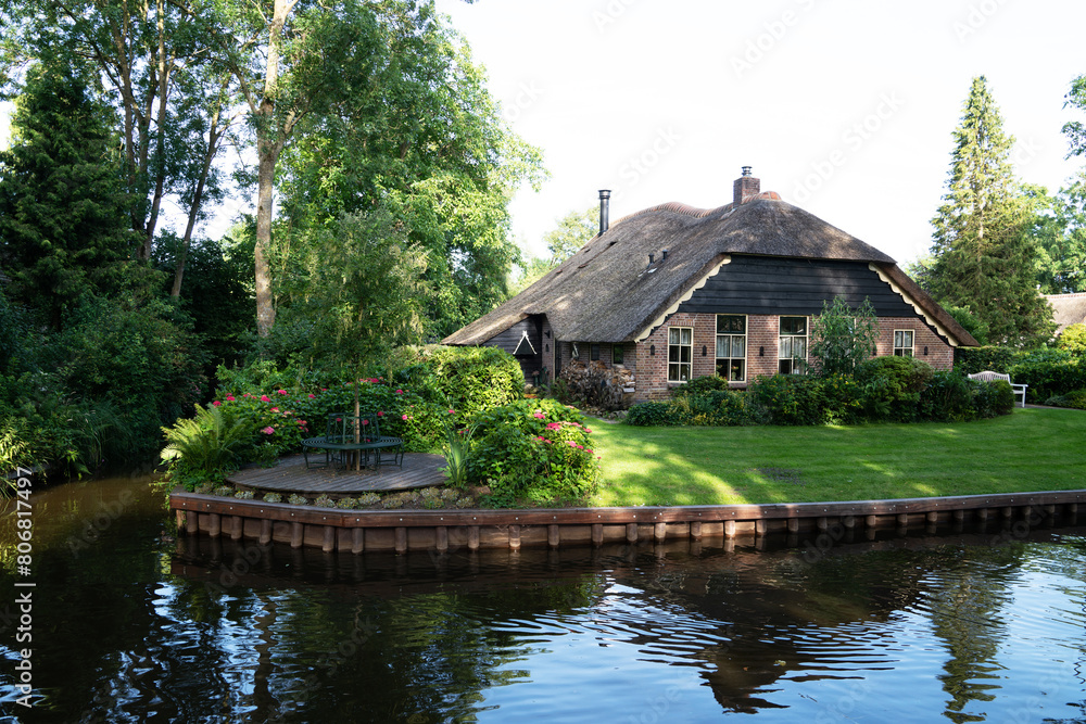 Typical houses of Giethoorn, Netherlands with gardens. Town is know as Typical houses of Giethoorn, Netherlands with gardens. Town is know as