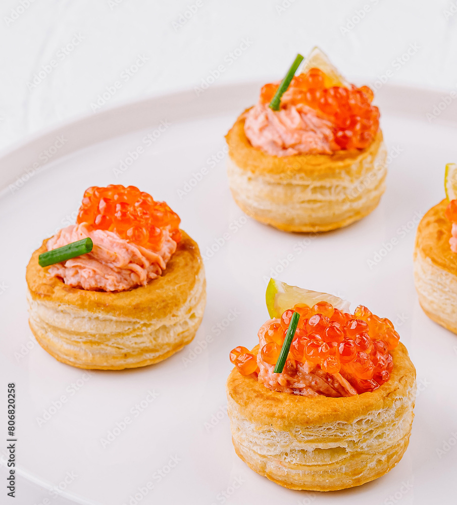 Elegant salmon tartare appetizers on white plate Elegant salmon tartare appetizers on white plate