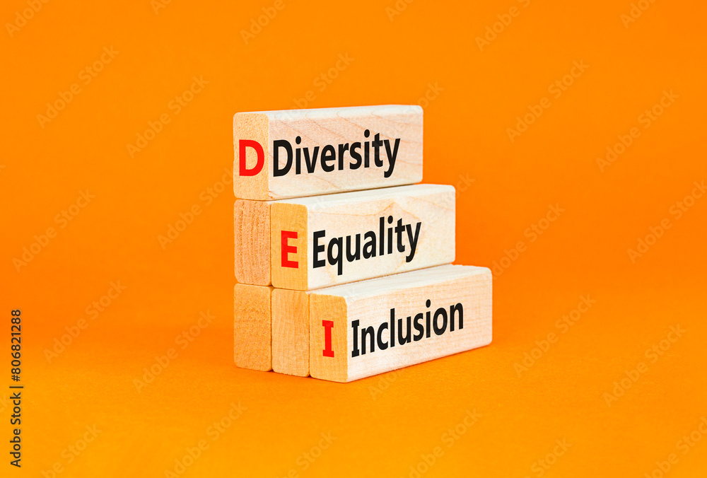 Naklejka premium DEI diversity equality inclusion symbol. Concept words DEI diversity equality inclusion on blocks. Beautiful orange background. Business DEI diversity equality inclusion concept. Copy space.