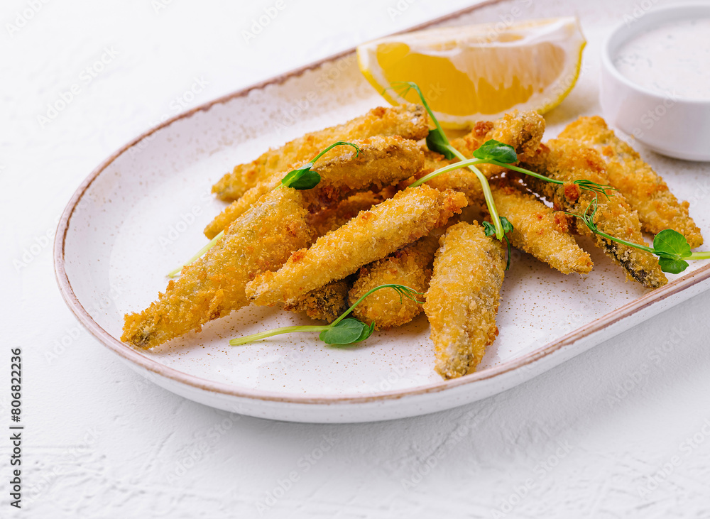 Crispy fried fish fingers with lemon and tartar sauce Crispy fried fish fingers with lemon and tartar sauce