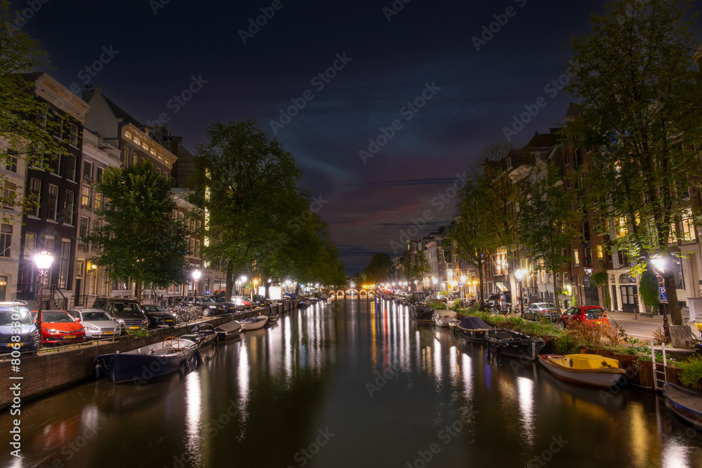 Boats and Cars Parked on the Amsterdam Canal at Night